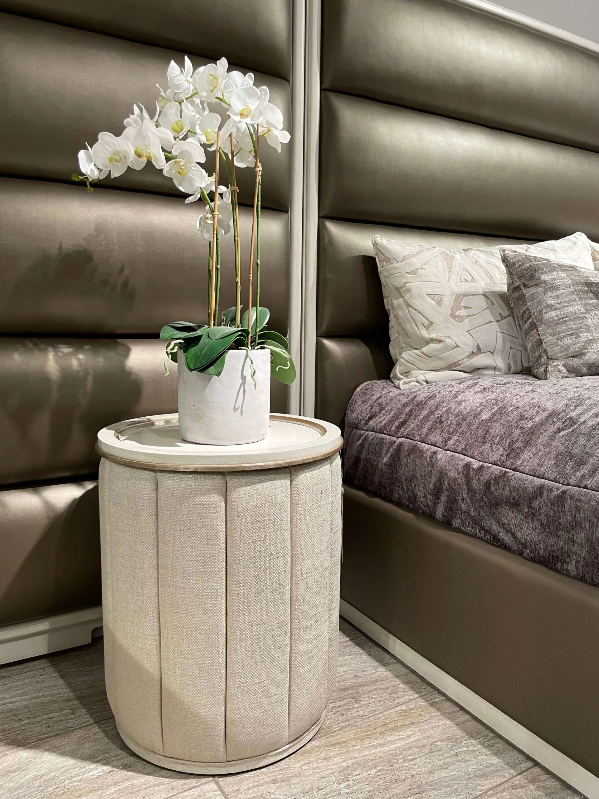 palo alto bed by marge carson with side panels in a bronze material and white wood trim closeup