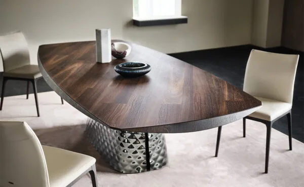 Cattelan Italia's Atrium Masterwood dining table burned oak wooden carved top and metal quilted base closeup detail shot at base slit.