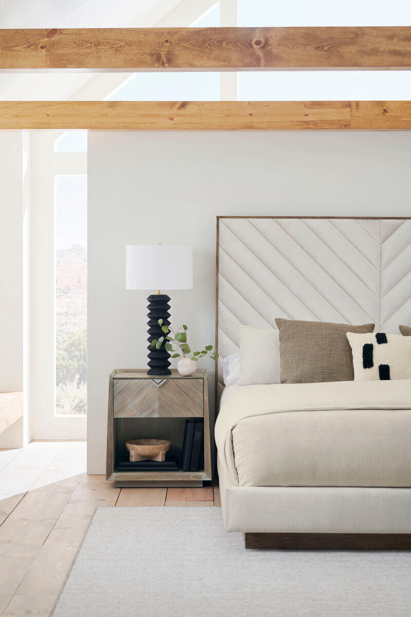 beige bed wood trim with chevron design headboard staged photo in white well lit room
