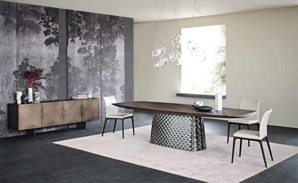 burned oak wooden carved top and metal quilted base in an empty room with white leather dining chairs